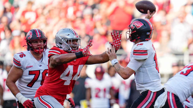 Sep 16, 2023; Columbus, Ohio, USA; Ohio State Buckeyes defensive end JT Tuimoloau (44) pressures Western Kentucky Hilltoppers quarterback Austin Reed (16) during the NCAA football game at Ohio Stadium. Ohio State won 63-10.  